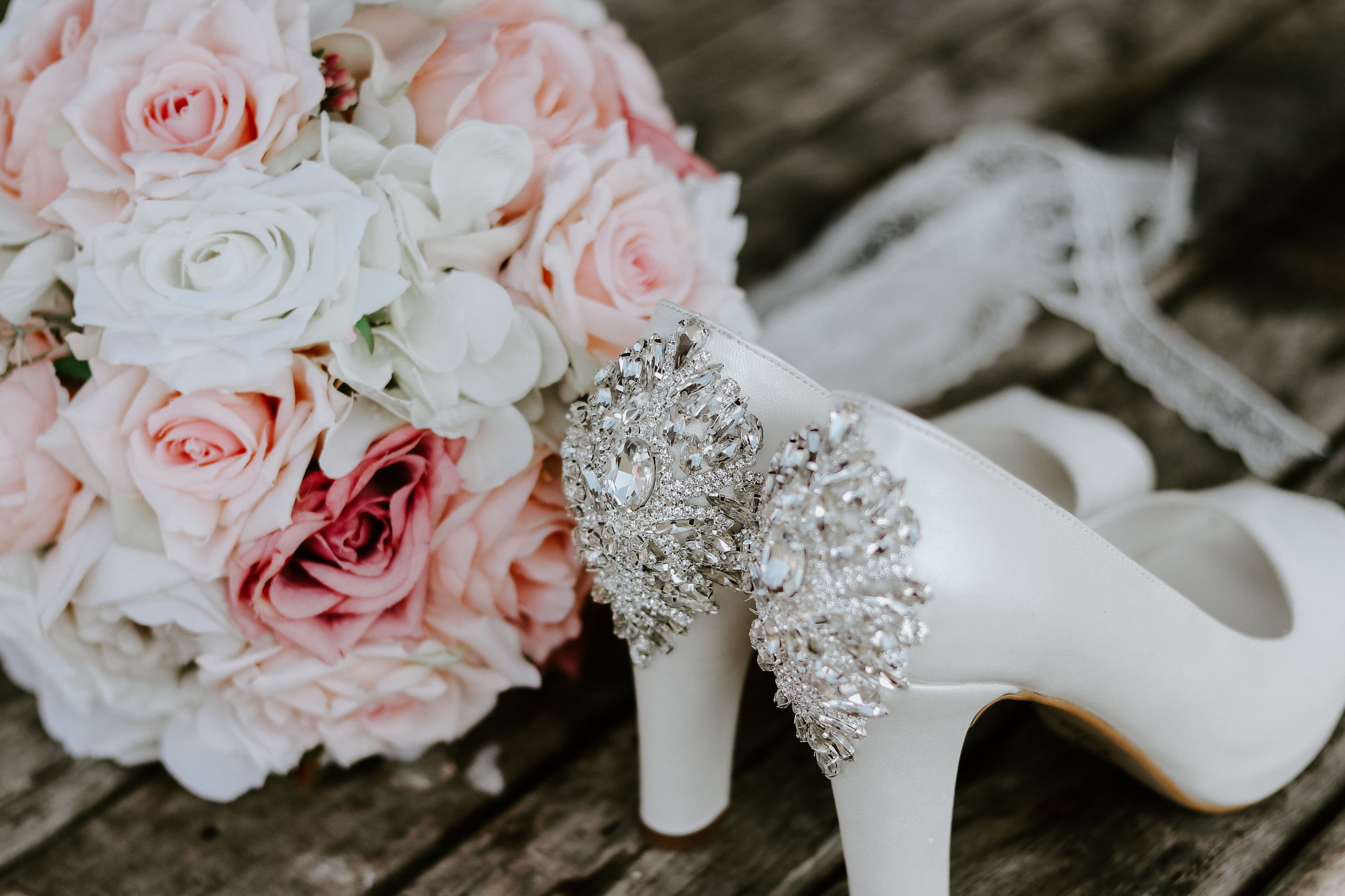 Close-up of wedding rings, florals and table details
